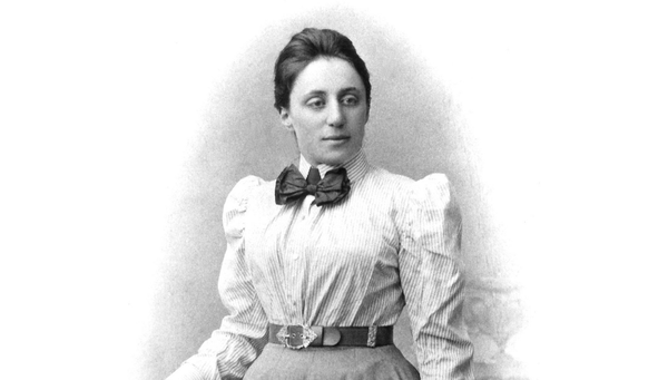 An old print of a photograph of a woman wearing formal clothes