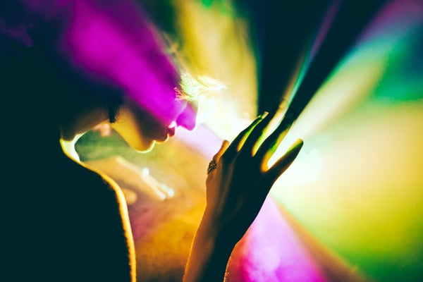 A futuristic woman exploring a bright and colorful outer space that evokes a psychedelic trip.
