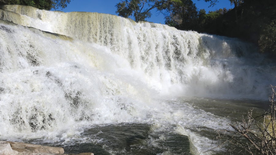 Water careens down a wide, rocky waterfall.