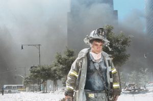 An unidentified New York City firefighter walks away from Ground Zero after the collapse of the Twin Towers on September 11, 2001, in New York City.