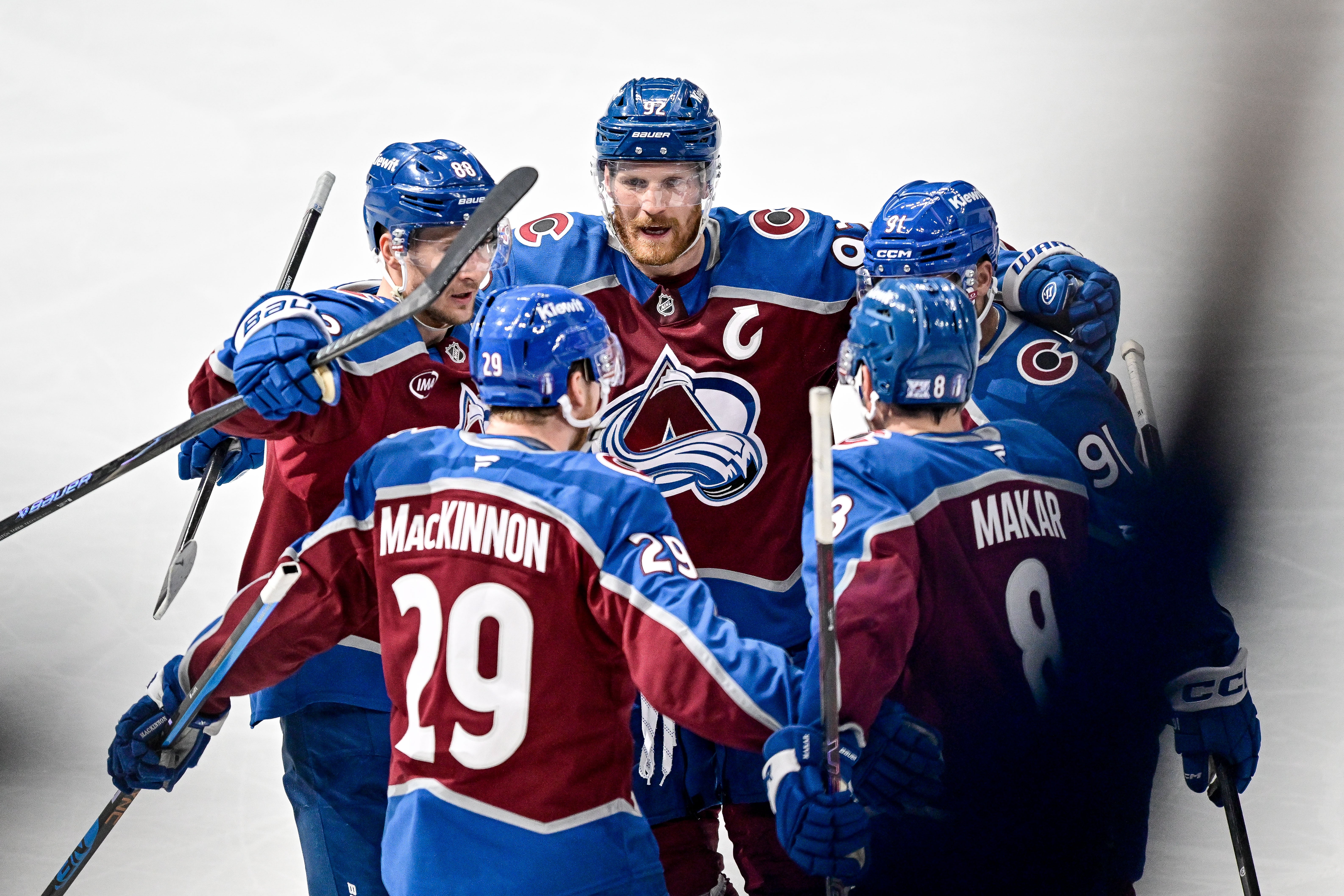 Colorado Avalanche players, including center Martin Necas (88), left wing Gabriel Landeskog (92), center Nazem Kadri (91) and defenseman Cale Makar (8), celebrate after a goal by center Nathan MacKinnon (29) at Ball Arena in Denver, Colo., on May 5, 2026.