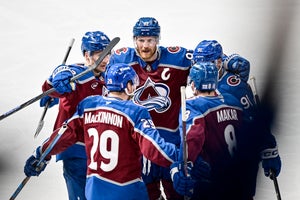 Colorado Avalanche players, including center Martin Necas (88), left wing Gabriel Landeskog (92), center Nazem Kadri (91) and defenseman Cale Makar (8), celebrate after a goal by center Nathan MacKinnon (29) at Ball Arena in Denver, Colo., on May 5, 2026.