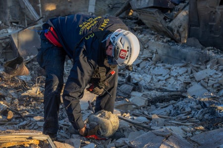 A member of the FEMA Urban Search and Rescue team searches the ruins of one of the thousands of homes that were destroyed by the Eaton Fire on January 11, 2025 in Altadena, California.