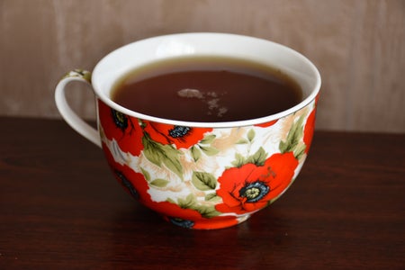 Cup of tea with poppyseed design.