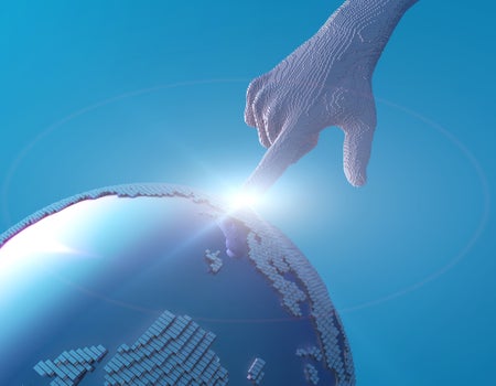 A stylized digital illustration of a 3D pixelated human hand reaching down to touch a glowing point on a fragmented, cube-like globe against a blue background, suggesting connection between humanity and technology.