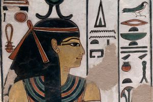 A mural with hieroglyphs and a depiction of a woman seen from the sidee