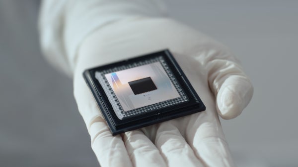 Gloved hand holding Google's Willow quantum computer chip