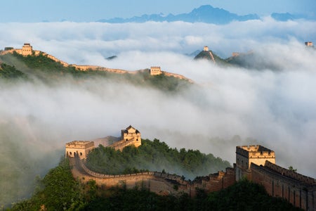 The Jinshanling Great Wall winding along mountaintops above a sea of clouds