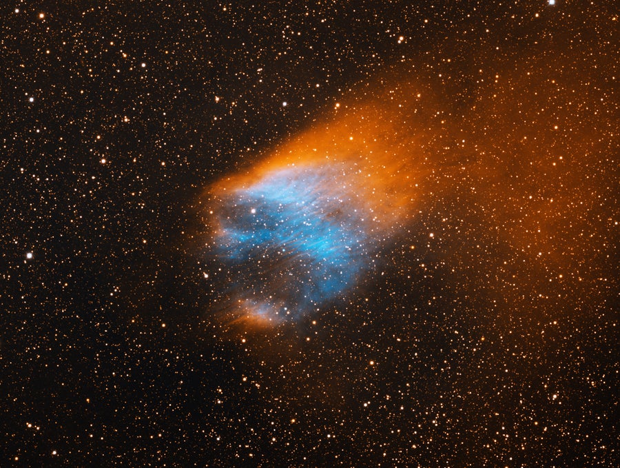 	Sh2-68 is an ancient planetary nebula that is estimated to be at least 45,000 years old. The diffuse orange emission to the upper right is the result of the planetary nebula's motion through the disk of our galaxy. The bluish interior is from energized oxygen atoms. The progenitor star is the very blue star at the center of the bluish gas. The image was generated with observations in the Hydrogen alpha (red) and Oxygen [OIII] (blue) filters. In this image, North is right, East is up