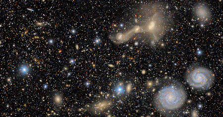 Animation zooming out from a close up to a wider view of colorful variety of galaxies and Milky Way stars