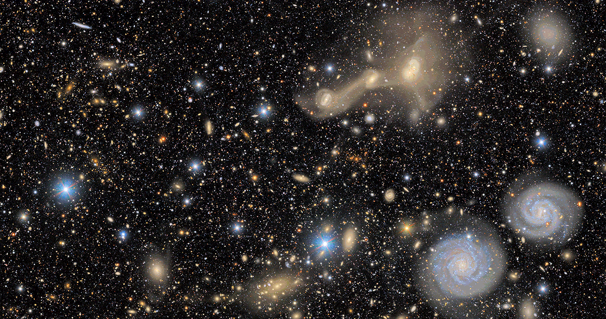 Animation zooming out from a close up to a wider view of colorful variety of galaxies and Milky Way stars