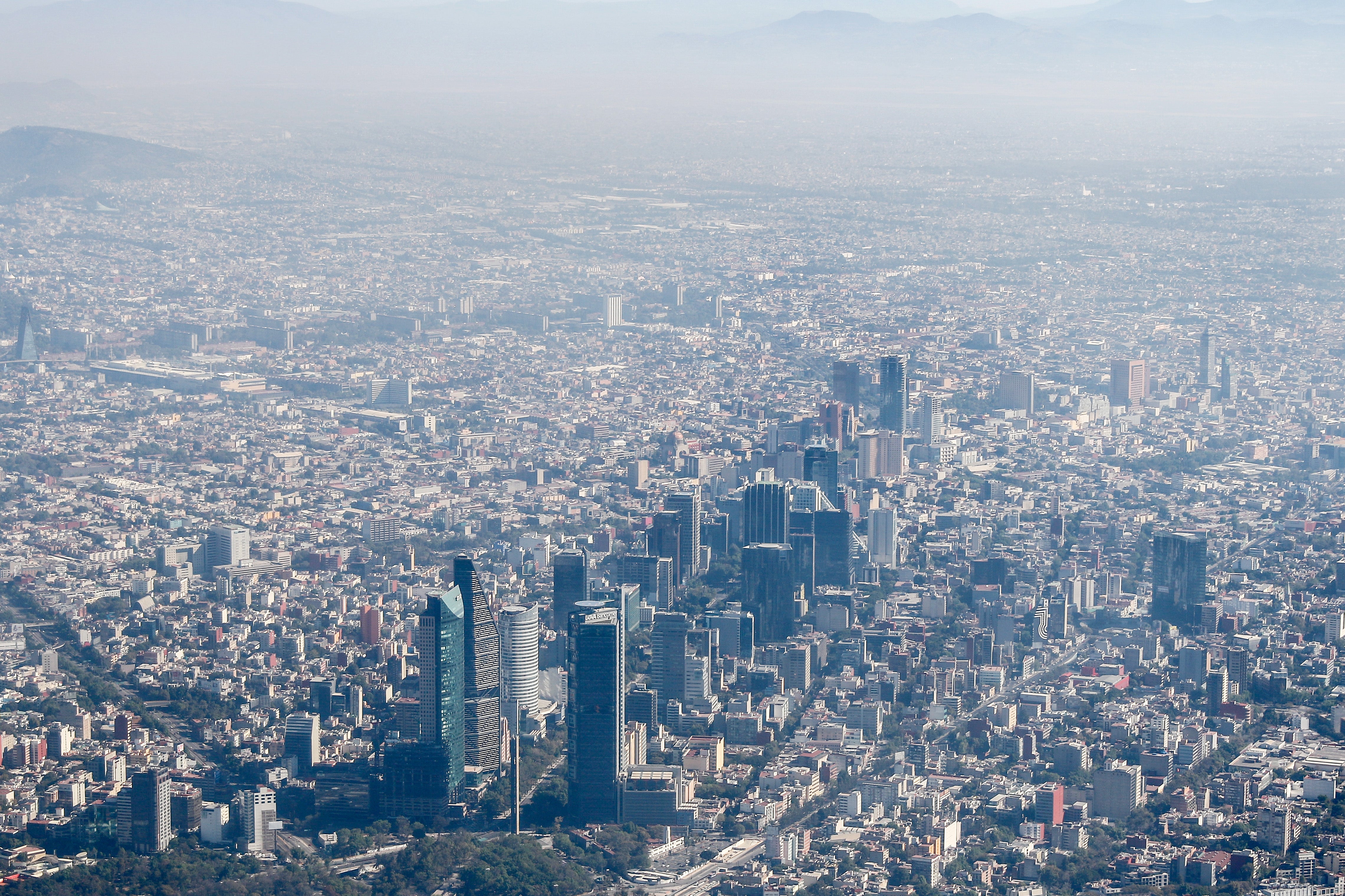 An aerial view of city clouded by smog.
