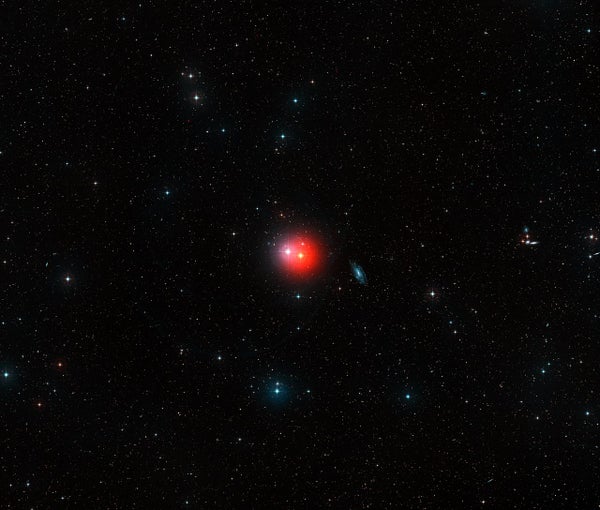 A view of the red giant star π1 Gruis as a small reddish dot in deep space.