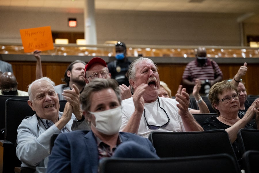 Audience members at a school board meeting in Kentucky protesting mask mandates and critical race theory