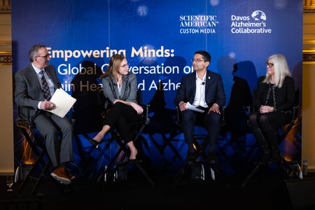 Four people sitting on a stage having a discussion.