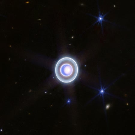 Uranus with bright polar cap, rings, and moons