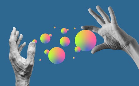 Photo-illustration showing hands with spheres against a blue backdrop.