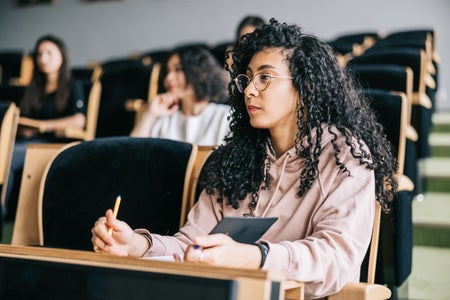 Young woman listening to university lecture