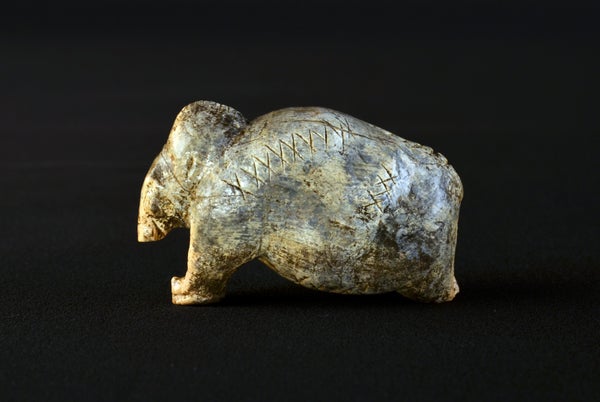 Mammoth figurine bears multiple sequences of crosses and dots on its surface