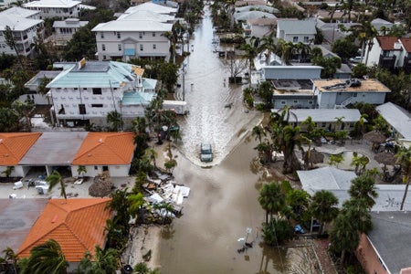 Aerial of car droving through flooded street