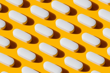 white pills on a orange-yellow background