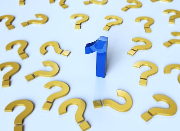 Gold question marks and a blue number 1 against a light blur background