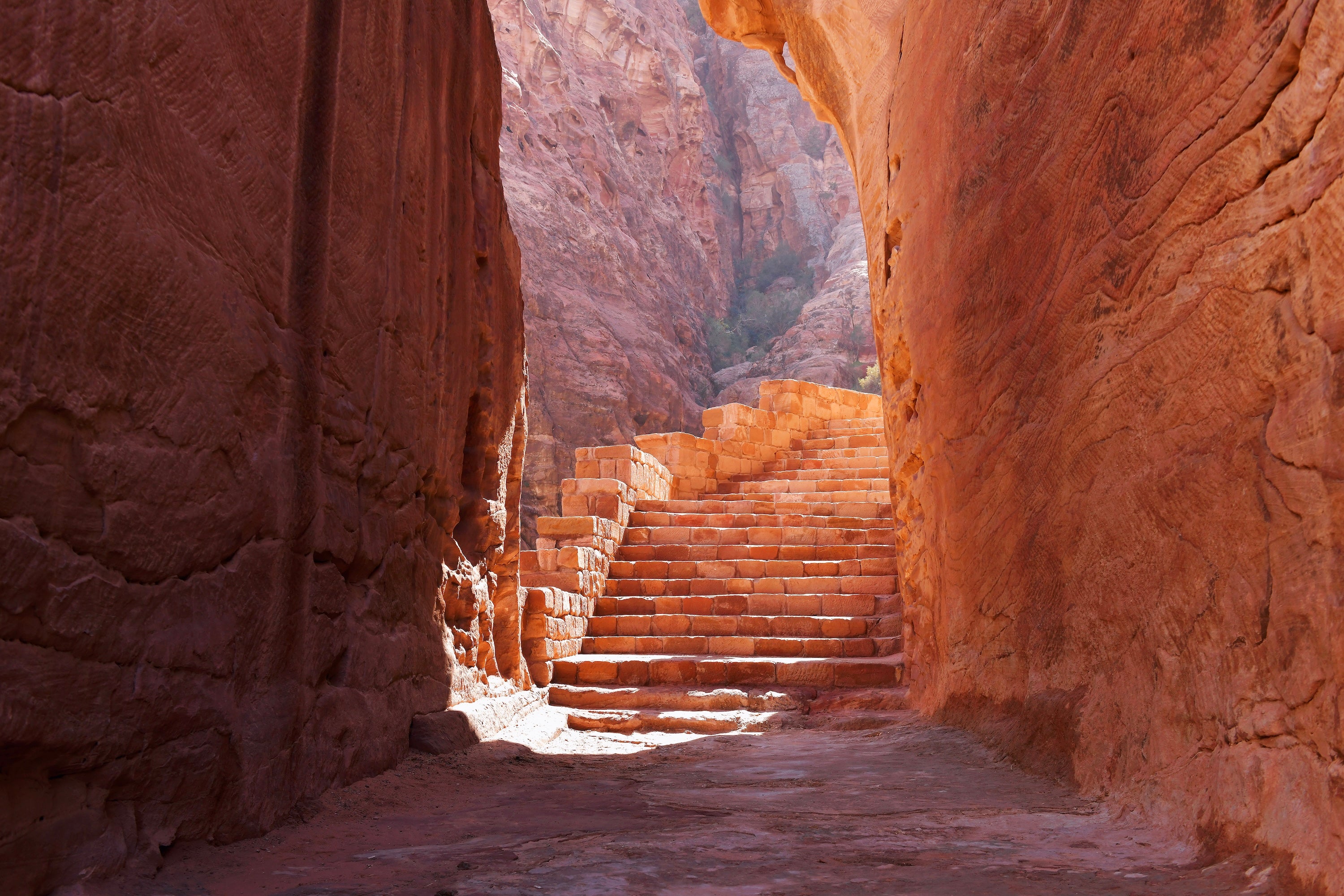 Carved stairs go upward as seen from narrow walls of an opening cave