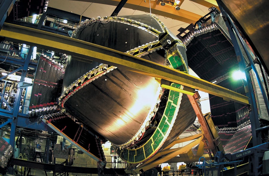 Large-scale metallic industrial equipment in an interior space.