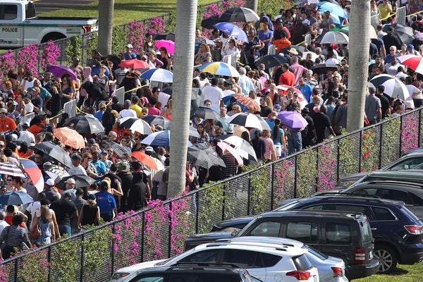 A dense crowd of people lined up waiting outside in Miami Gardens, Florida