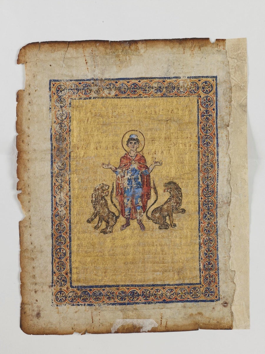 Illustration of the prophet Daniel next to two lions
