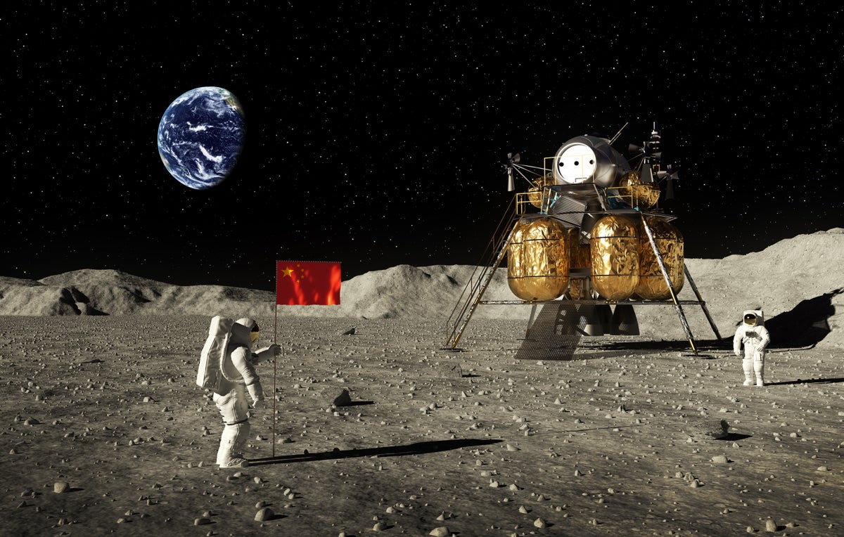 Two space-suit-wearing astronauts—one who is standing next to a Chinese flag and another who is standing next to a lunar lander spacecraft—on the surface of the moon. Earth appears in the distant background. 