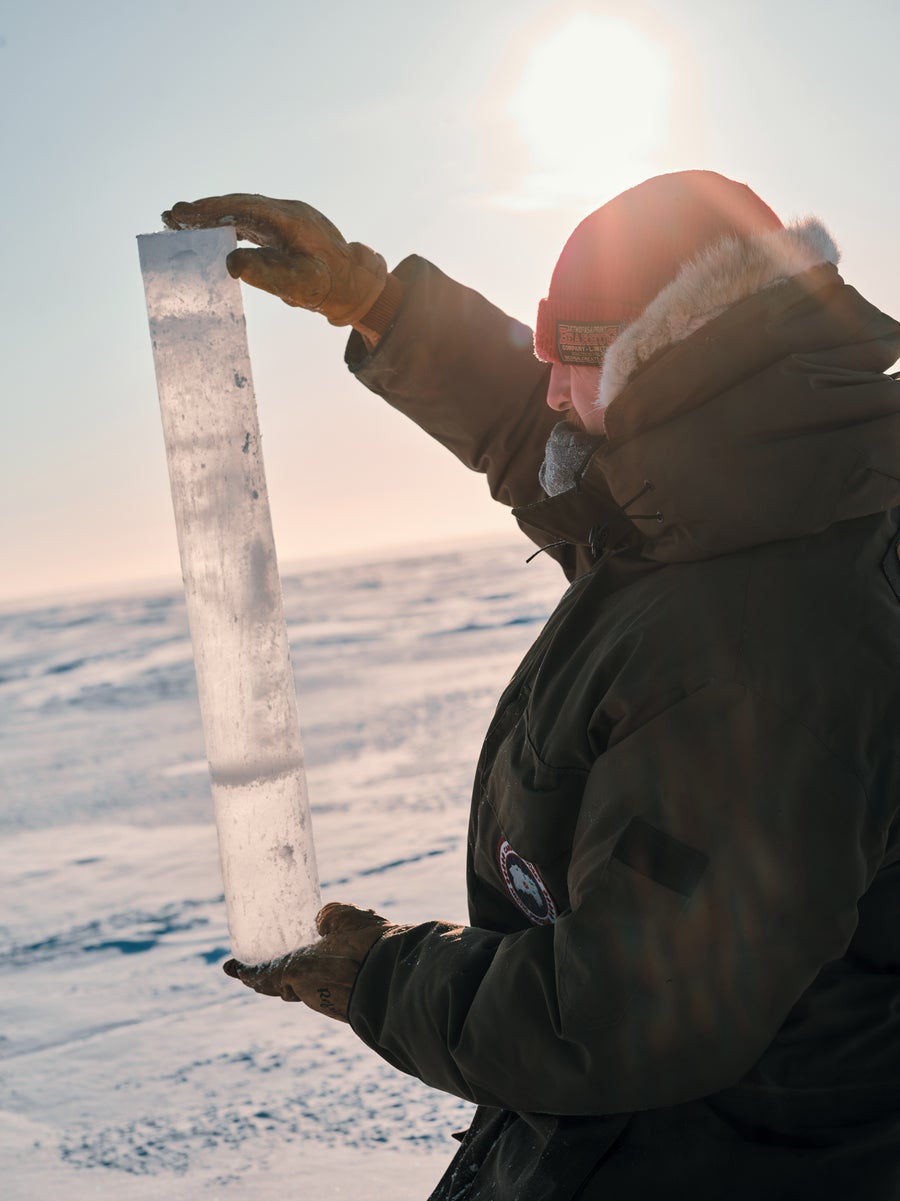 Man holding a long piece of ice.