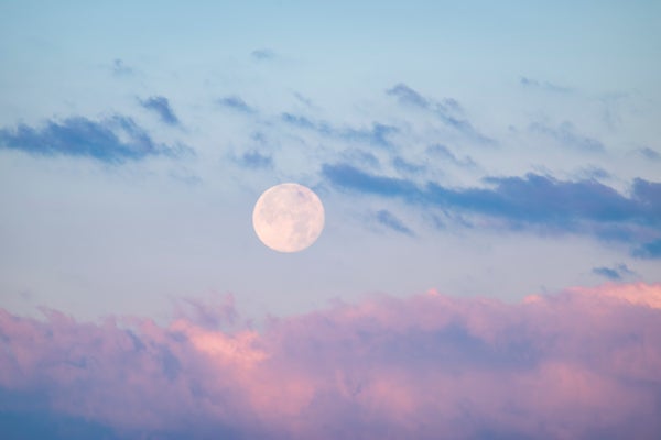 Full moon above pink clouds