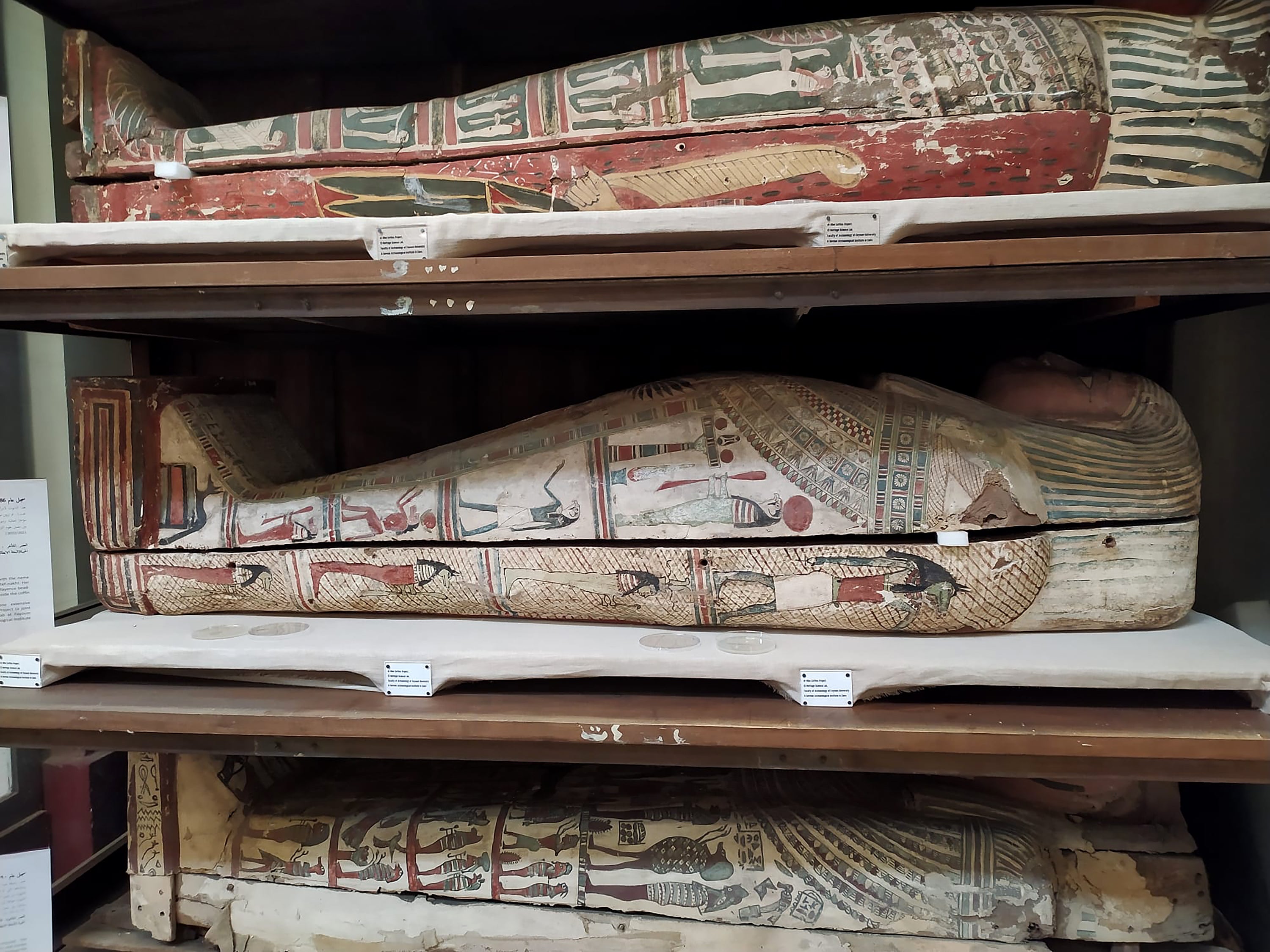 Three sarcophagi on shelves