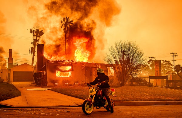 Motorcyclist watches as house engulfs in flames