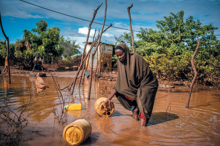 A woman collecting her items from the water