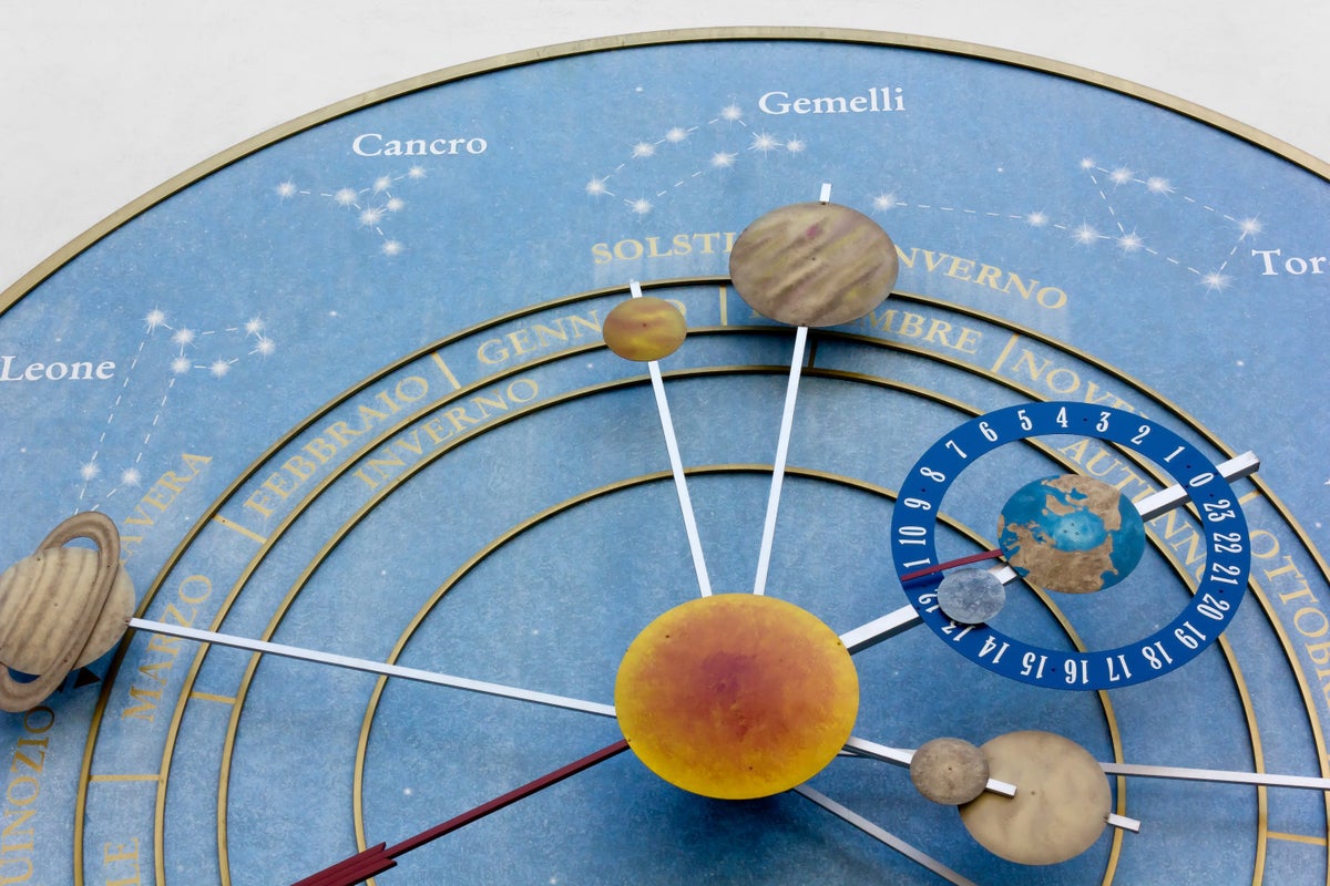A clock festooned with pictures of various planets of the solar system.