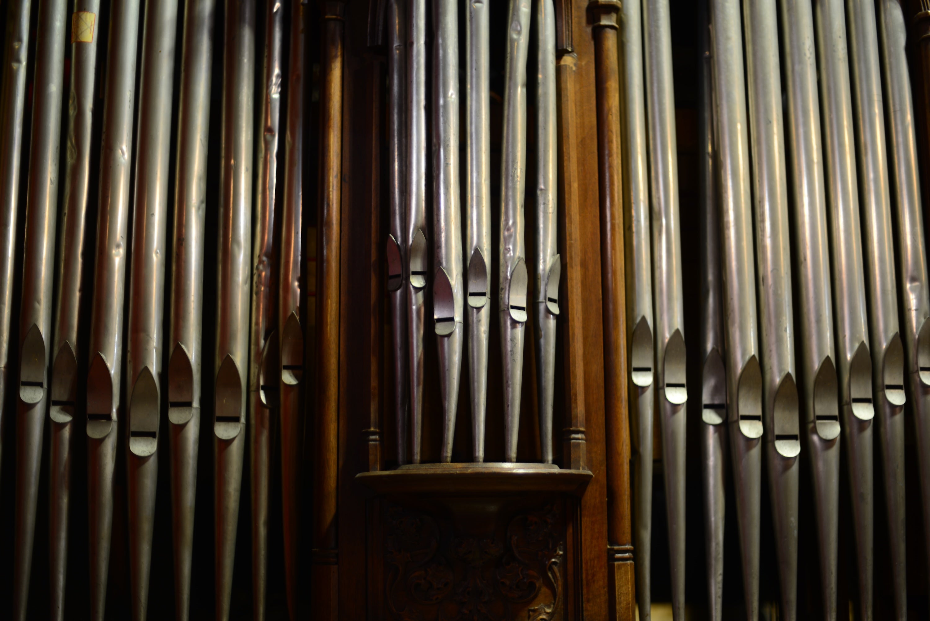 Close-up of the silver pipes on a vintage organ.
