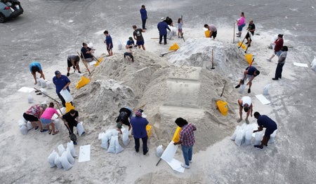 Aerial view of people preparing sandbags ahead of Hurricane Helene landfall