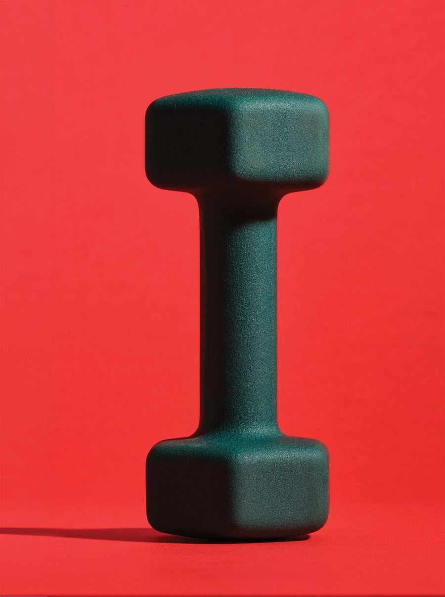 A dumbbell against a red background