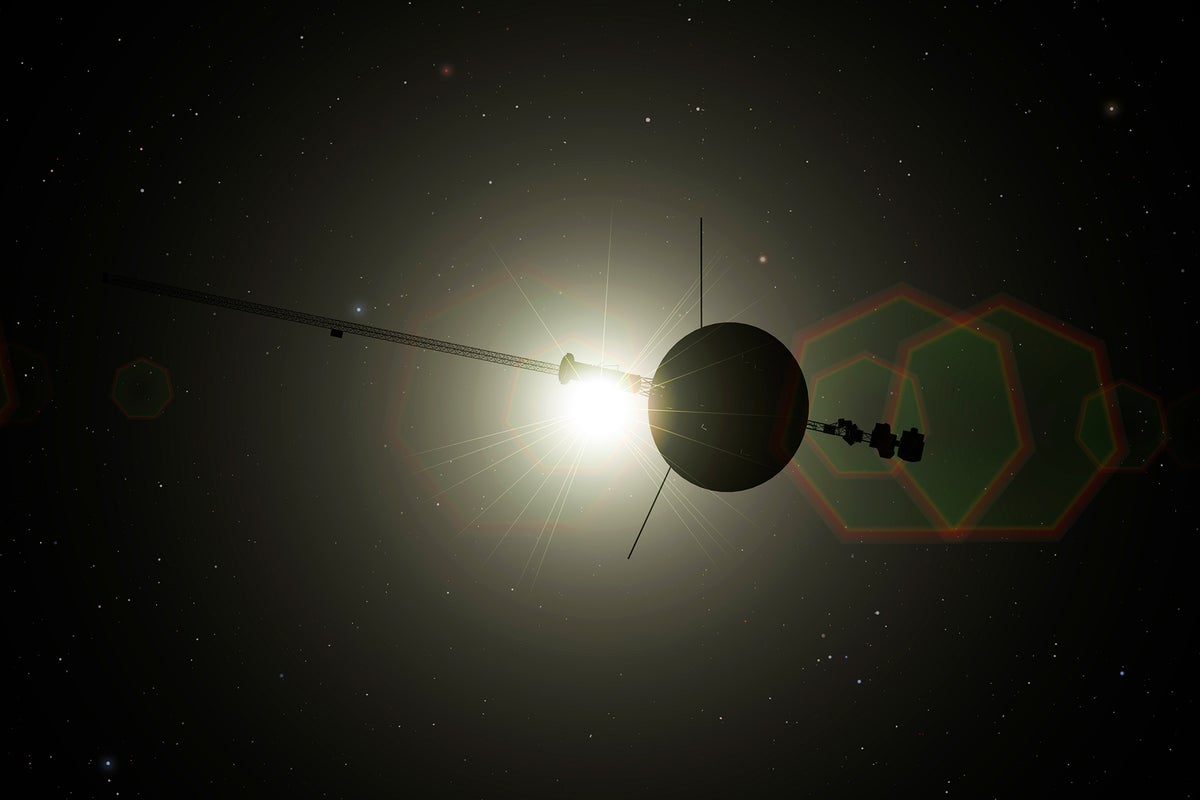 Voyager spacecraft leaving Solar System. The spacecraft is in silhouette with the light from the distant sun shining through 