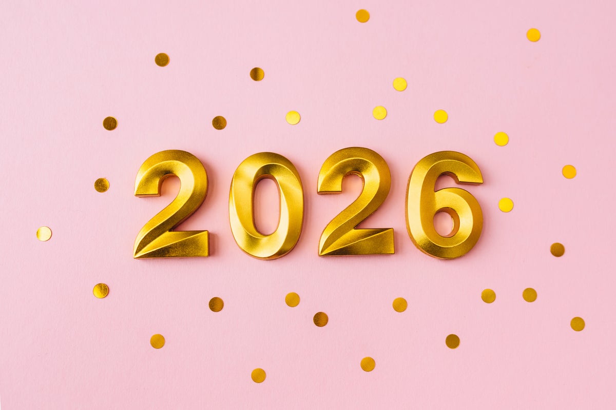 Golden new year 2026 numbers among confetti on pink background