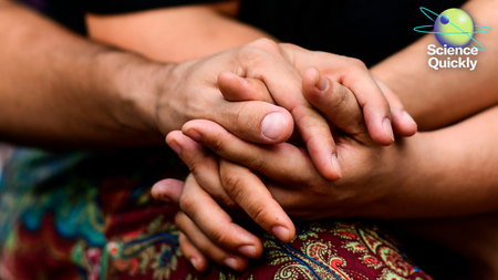 An image of three people holding hands.