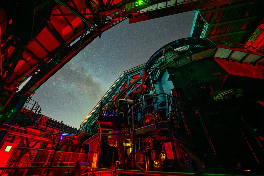 Rubin Observatory's massive telescope pointed upward toward the night sky visible through the rectangular dome opening