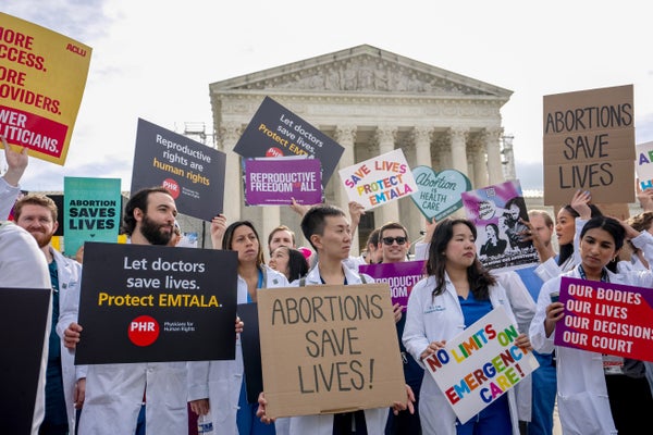 Doctors hold signs at abortion rights rally