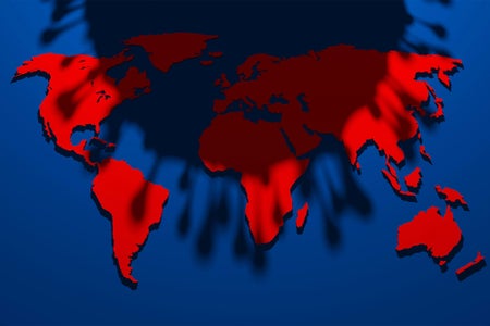 Shadow of a virus cell looming over a red and blue map of the world