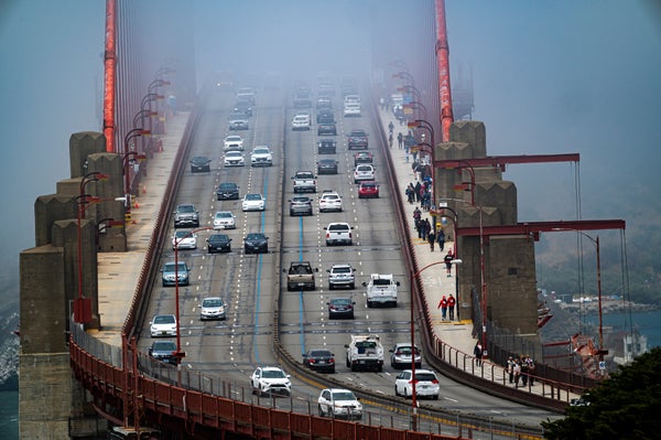 Cars on the Golden gate bridge in slight fog.