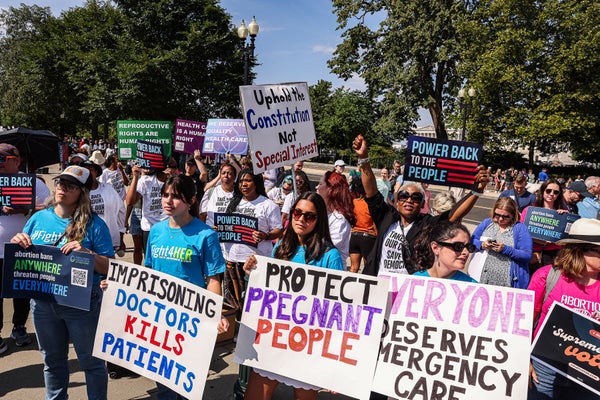 Crowd of women protesting with various signs.