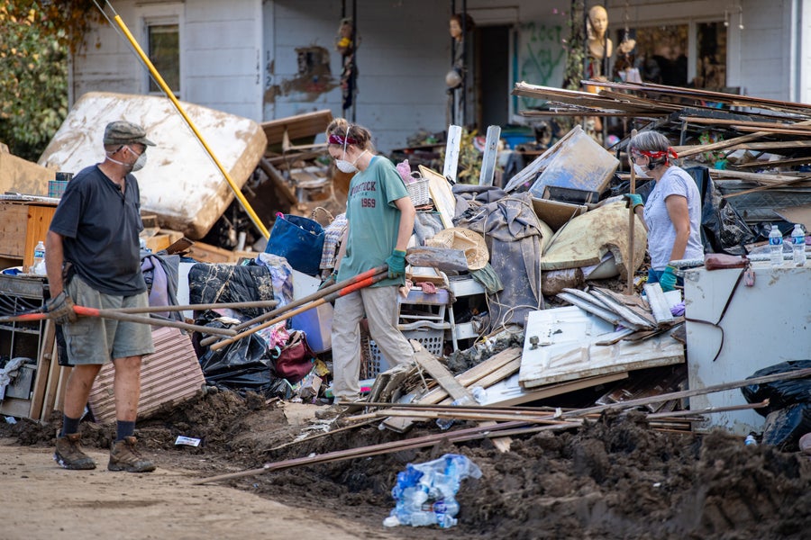 Volunteers work to remove debris and mud from flooded a home on Edwards Avenue in Beacon Village neighborhood after a catastrophic flooding caused from Hurricane Helene caused the Swannanoa river to swell to record levels October 5, 2024 in Swannanoa, North Carolina.