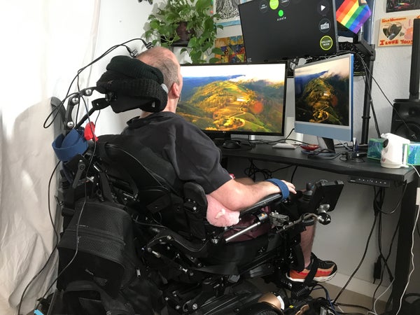 Trial participant, Casey Harrell, who has lost his ability to speak due to ALS, using the BrainGate2 BCI while seated in his mobility device